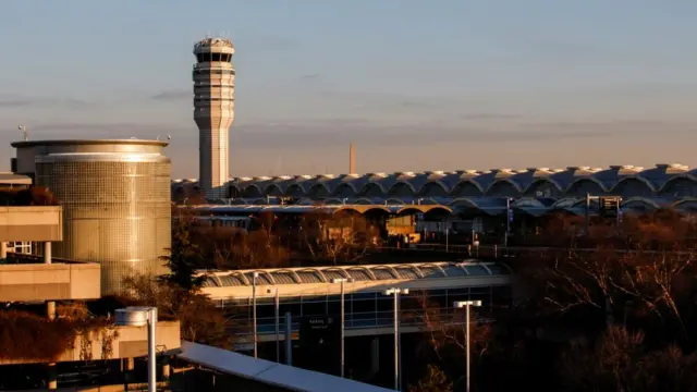 A general view of Ronald Reagan Washington National Airport. The sun is rising so the airport is covered in golden light.