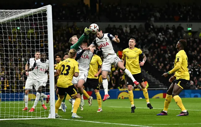 Isak Pettersson punches the ball away from the head of Ben Davies