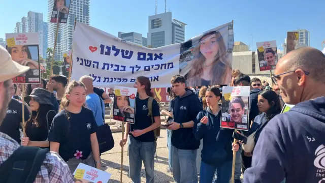 Crowd holding banners of Agam Berger