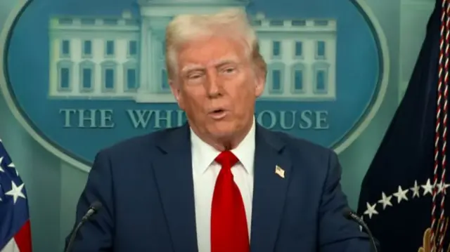 Donald Trump mid shot as he stands behind lectern