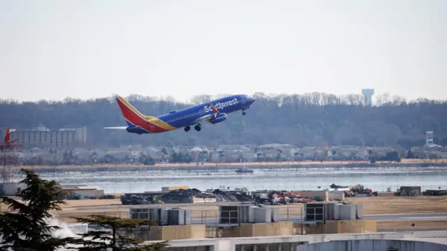 A flight takes off from Reagan National Airport, with the Southwest logo on the side