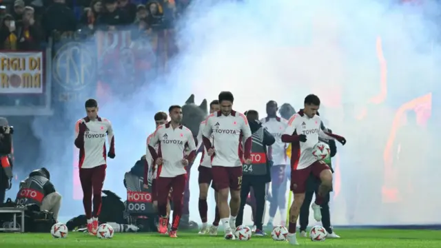 Roma players run onto the pitch