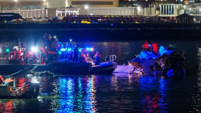 Rescuers search wreckage in water