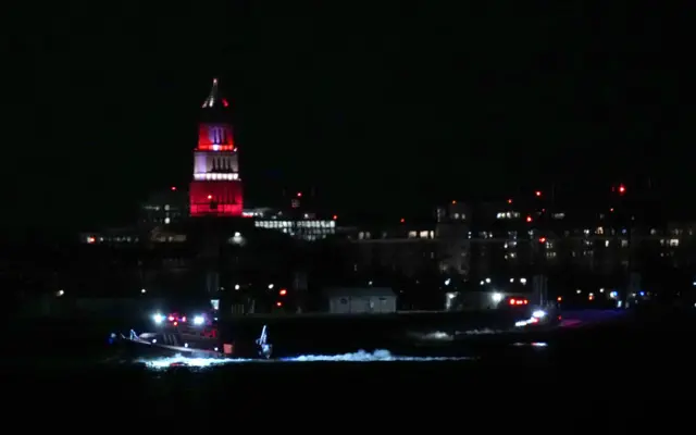 Emergency response units conduct search and rescue operations in the Potomac River near Ronald Reagan Washington Airport