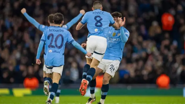 Man City players celebrate after scoring against Club Brugge