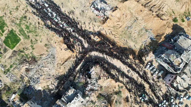 Drone shot of crowds on roads near hostage release