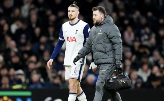 Tottenham Hotspur's Radu Dragusin goes off injured