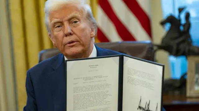 Trump shows a memo that he signed