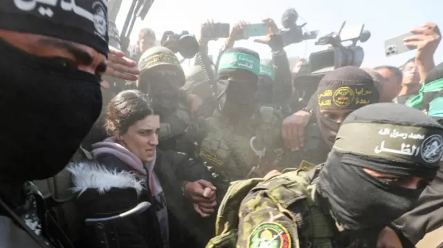 Arbel Yehud being led through crowds in Khan Younis earlier