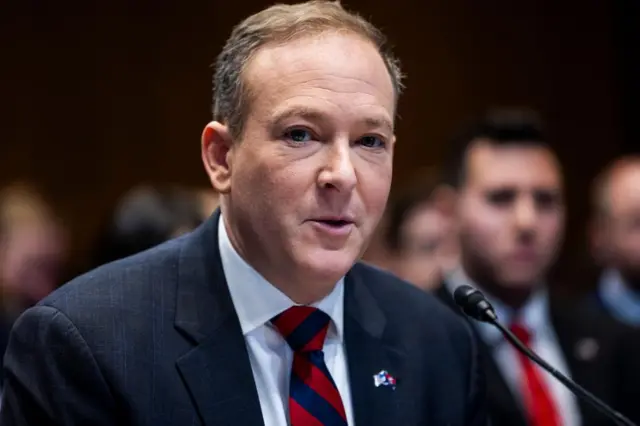 Lee Zeldin speaks into a microphone at a confirmation hearing in the Senate office building on 16 January. He wears a dark suit and a red and navy striped tie.