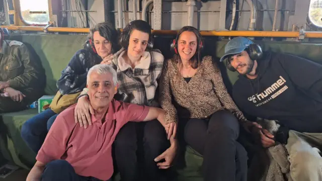 A family picture featuring Arbel Yehud with her parents, brother and sister-in-law. Arbel wears a checked jacket.