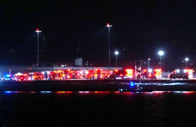 Emergency response units conduct search and rescue operations in the Potomac River near Ronald Reagan Washington Airport