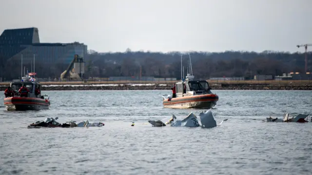 Coast Guard boats on the river next to debris