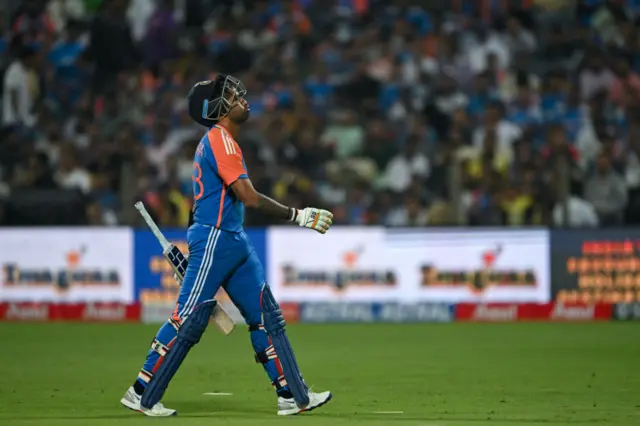 India's captain Suryakumar Yadav walks back to the pavilion after his dismissal during the fourth Twenty20 international cricket match between India and England at the Maharashtra Cricket Association Stadium in Pune