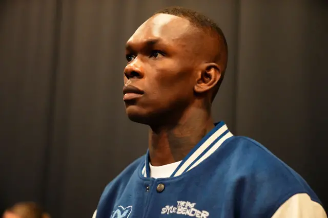 Israel Adesanya wearing a blue and white jacket