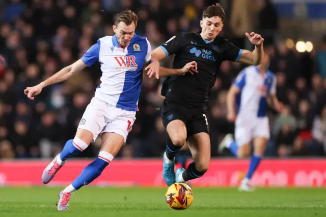 Ryan Hedges of Blackburn Rovers battles for possession with Jordan Storey