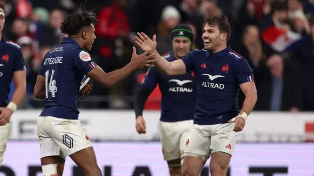 Theo Attissogbe (left) celebrates scoring France's third try with scrum-half and captain Antoine Dupont