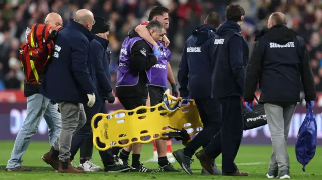 Owen Watkin of Wales is helped off the field with a game ending injury