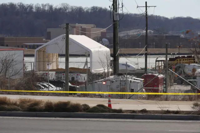 Officials set up a tent for recovery efforts