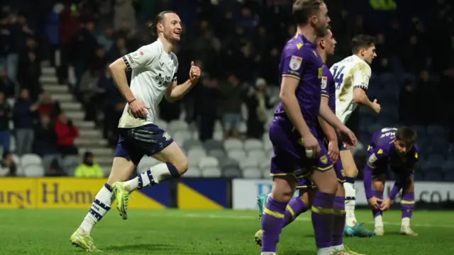 Preston's Will Keane runs back to the halfway line smiling after scoring against Oxford