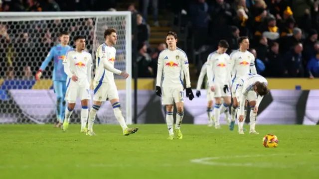 Leeds players trudge back to the halfway line after conceding a third to Hull