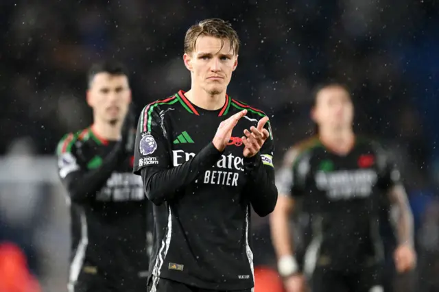 Odegaard applauds the away fans at full time