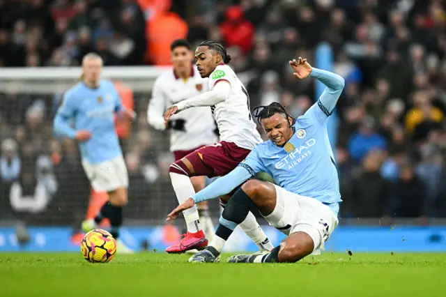 Crysencio Summerville fights for the ball with Manchester City's Swiss defender Manuel Akanji