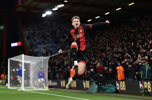 Brooks jumps into the air to celebrate his goal v Everton