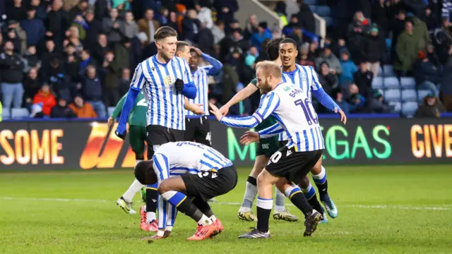 Sheffield Wednesday's Ike Ugbo is consoled by team-mates after missing a penalty against Millwall