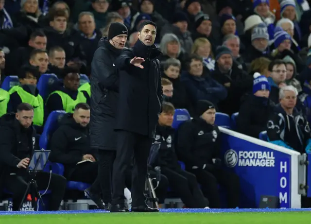 Arteta waves his arm from the touchline