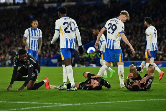 Several Arsenal players lie on the floor after a corner