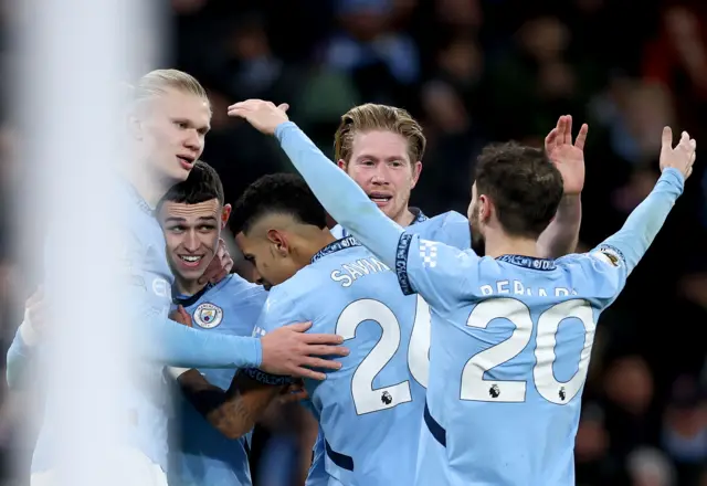 Man City players celebrate with Foden after his goal