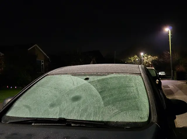 A car windshield covered in ice