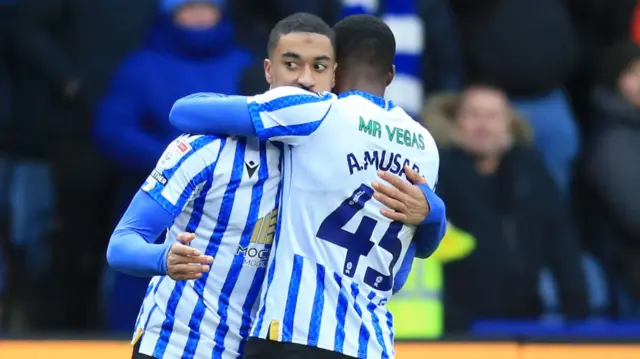 Sheffield Wednesday goalscorer Yann Valery is congratulated by team-mate Anthony Musaba