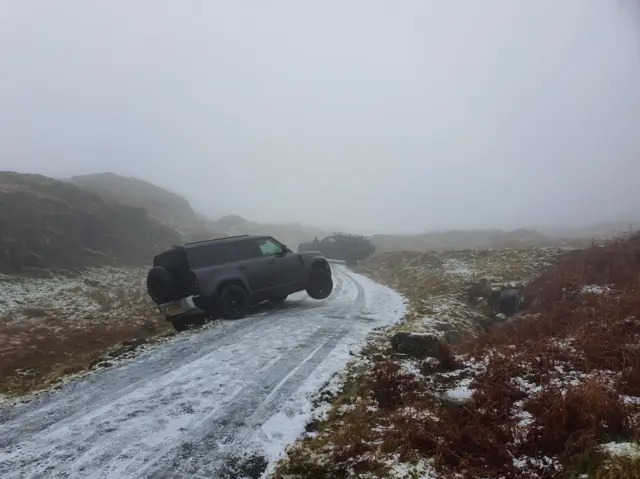 a car has swerved off the road at Wrynose Pass in the Lake District