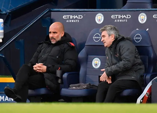 Pep Guardiola looks on