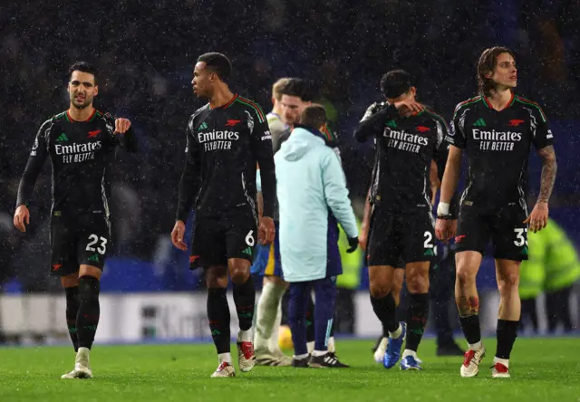 Arsenal players walk around dejected at full time