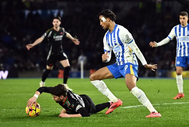 Jorginho falls on the ball after pressure from Joao Pedro