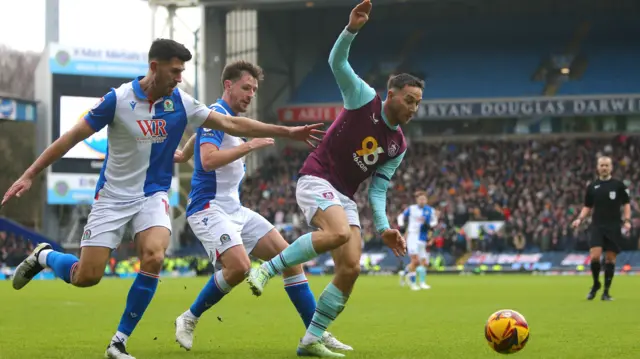 Burnley's Josh Brownhill tries to keep possession under pressure from two Blackburn players