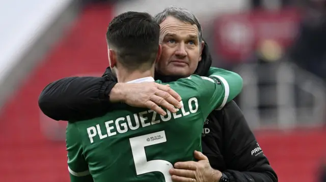 Kevin Nancekivell hugs Plymouth defender Julio Pleguezuelo