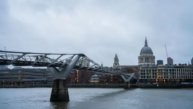 A view of Millennium Bridge leading to St. Paul's Cathedral, in London from the opposite side of the Thames