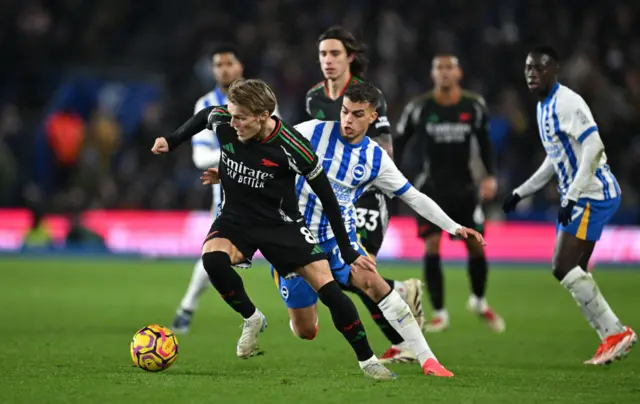 Odegaard tries to hold the ball under pressure