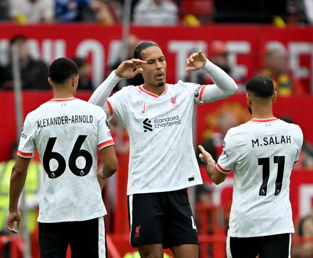 Trent, Salah and van Dijk high five