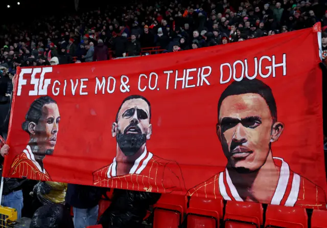 Banner on the Kop reading 'Give Mo and Co their dough'