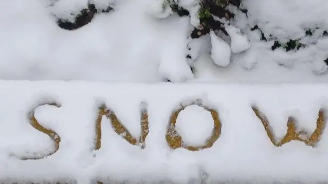 The letters SNOW written in the snow