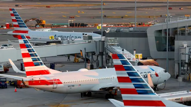 American Airlines planes sit parked at LaGuardia airport