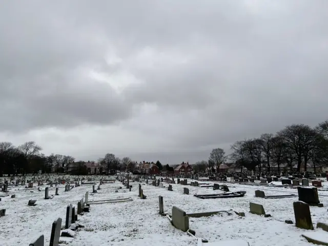 A cemetery covered in snow.