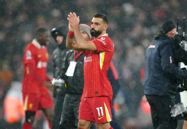 Salah claps the fans at full time