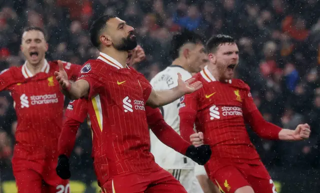 Salah celebrates with teammates