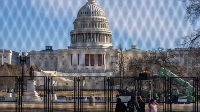 The US Capitol building is seen through security fencing on the National Mall ahead of the January 6th certification of the 2024 Presidential Election in Congress in Washington, DC, on January 5, 2025